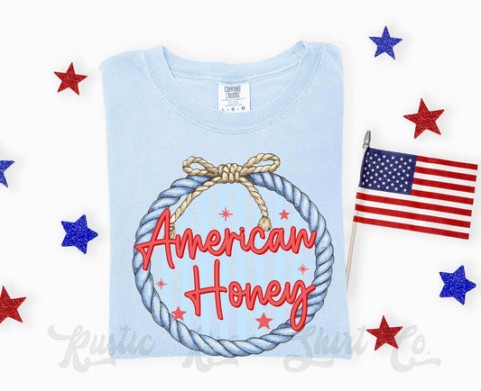 Light blue t-shirt with 'American Honey' design and American flag on a white background