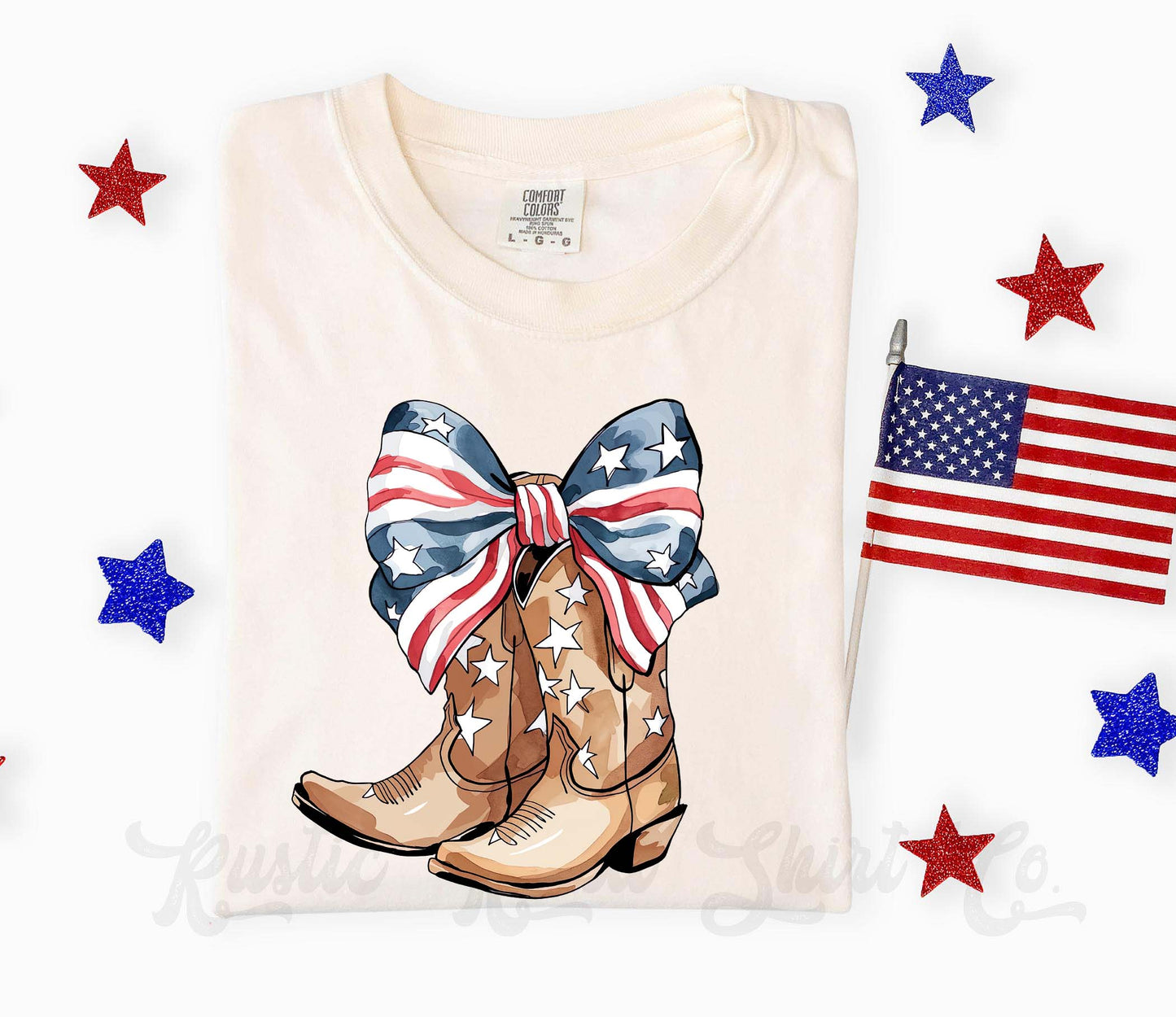 Folded t-shirt with cowboy boots and American flag design on a white background with stars and a flag.