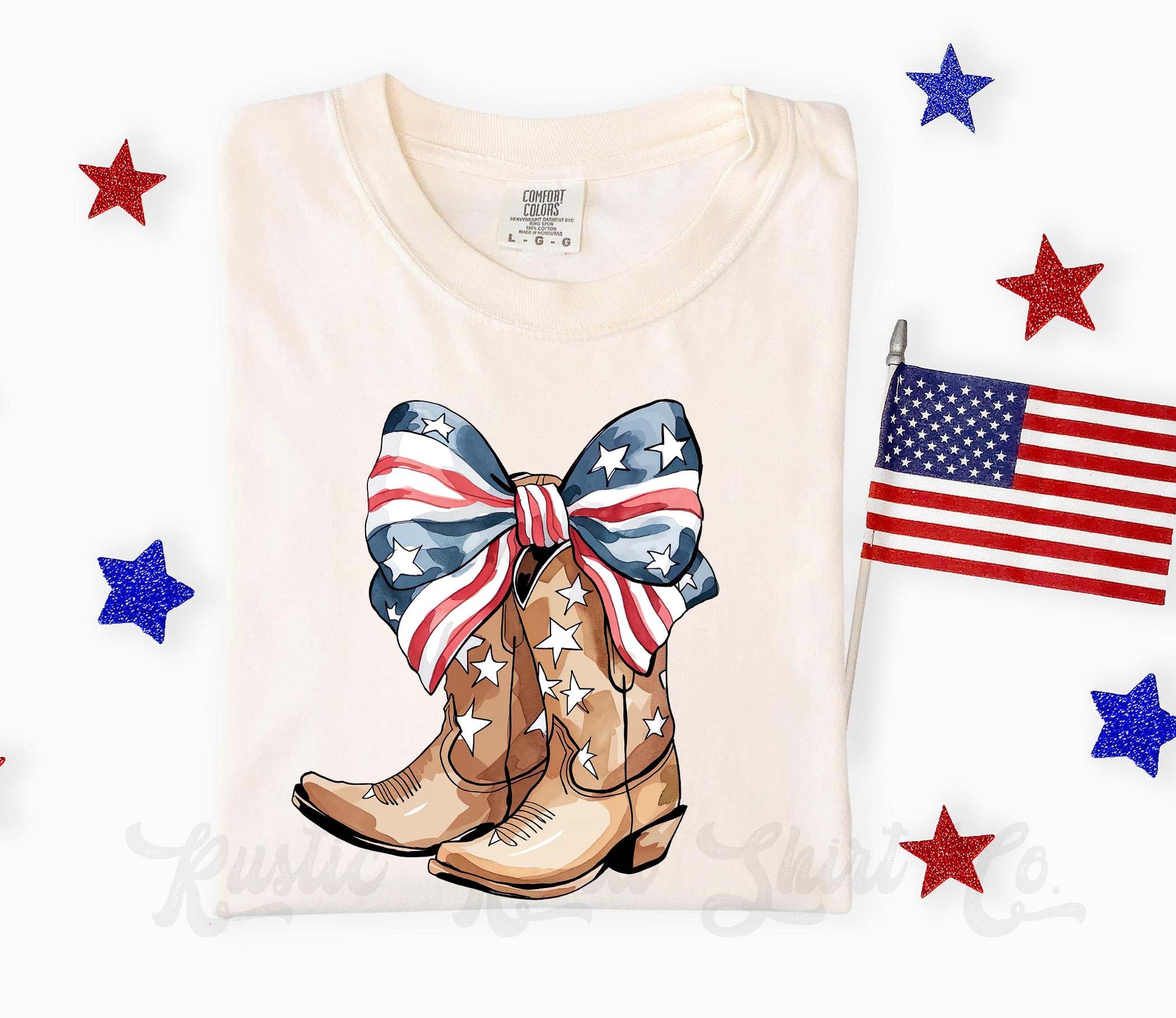 Folded t-shirt with cowboy boots and American flag design on a white background with stars and a flag.
