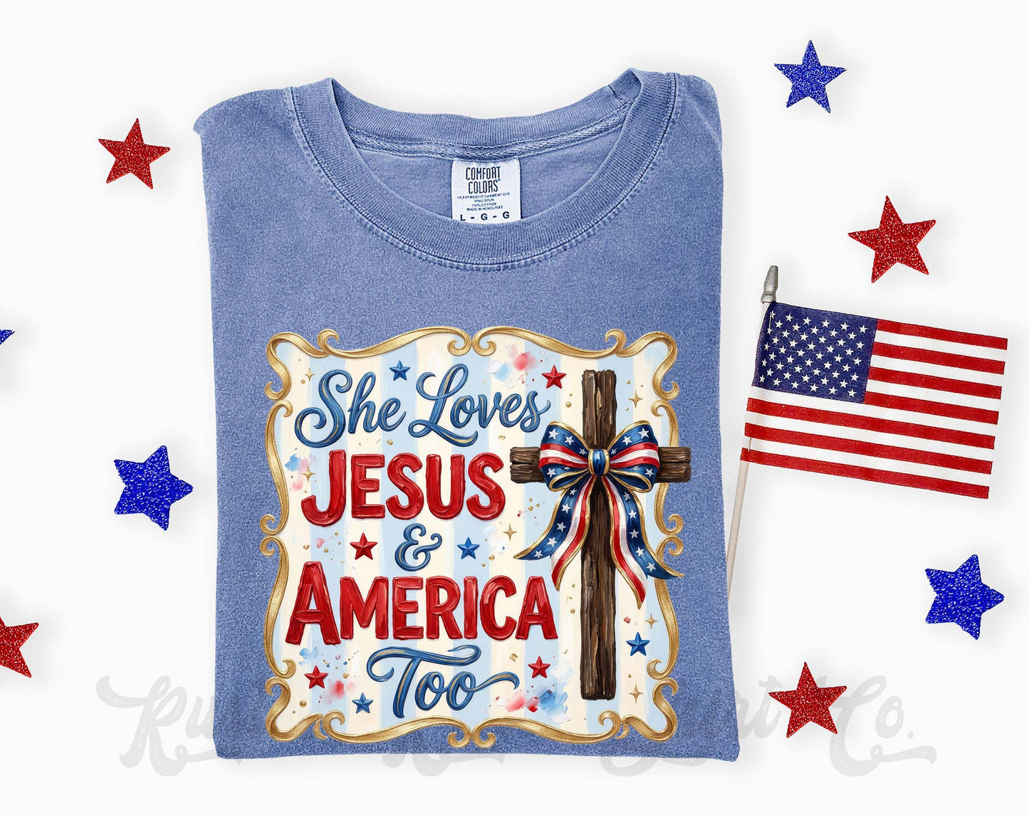 Blue t-shirt with 'She Loves Jesus & America Too' design, surrounded by American flags and stars on a white background.